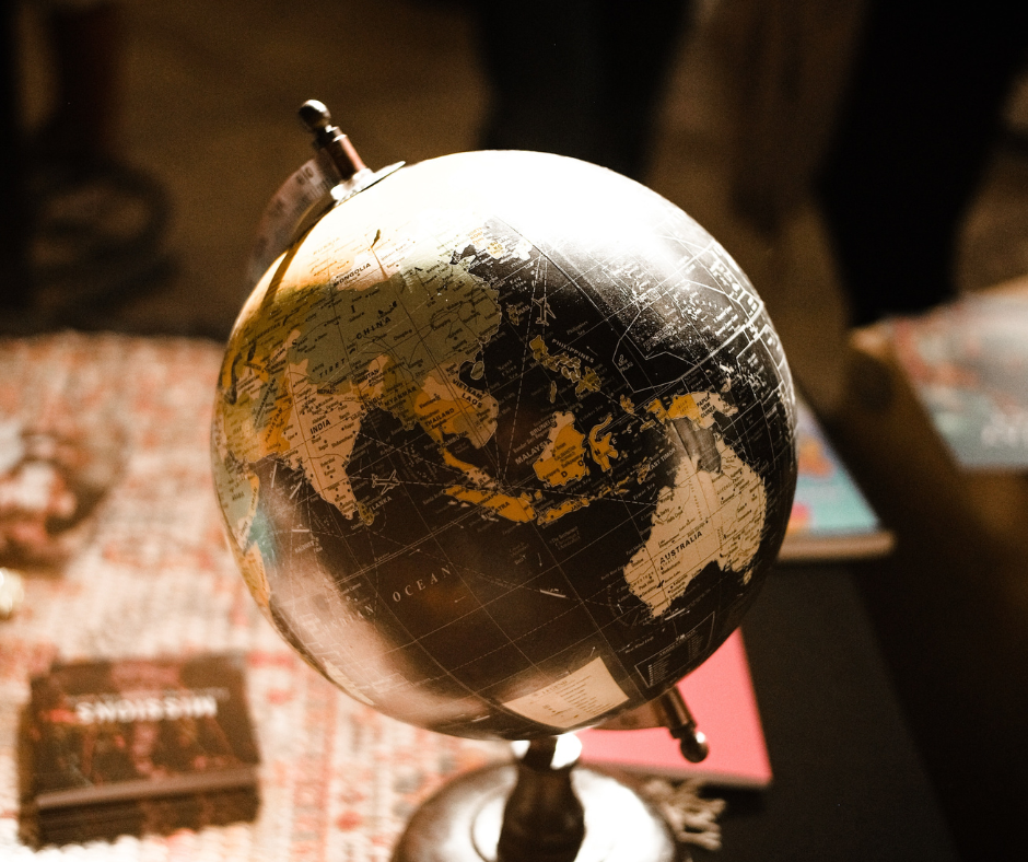 A globe sits on a desk.